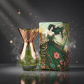 Zariya perfume bottle with rose gold cap and green liquid, next to its decorative box featuring a woman in a green dress.